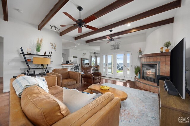 living room with ceiling fan, a fireplace, recessed lighting, wood finished floors, and beamed ceiling