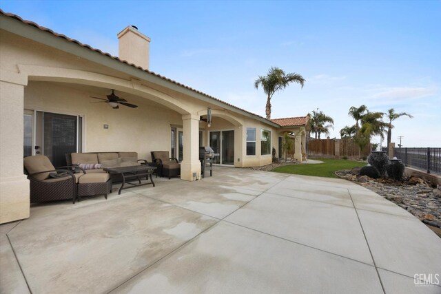 view of patio / terrace with fence, a ceiling fan, and outdoor lounge area