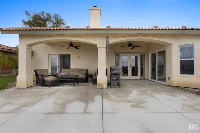 rear view of house featuring a ceiling fan, french doors, outdoor lounge area, and a patio area