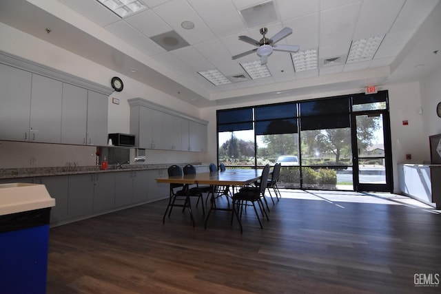 5712 Wisteria Valley Rd, Bakersfield, CA 93306 - dining room featuring a tray ceiling, dark wood-style flooring, a ceiling fan, and a drop ceiling