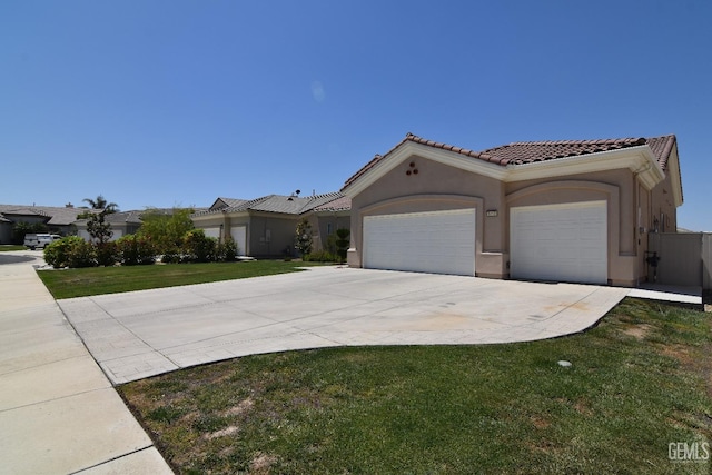 5712 Wisteria Valley Rd, Bakersfield, CA 93306 - mediterranean / spanish-style house featuring a garage, a tile roof, driveway, stucco siding, and a front yard
