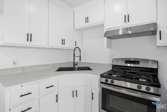 164 Rodriguez Ave, Shafter, CA 93263 - kitchen with stainless steel gas range oven, under cabinet range hood, and white cabinetry