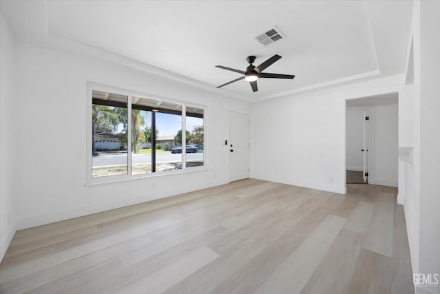 164 Rodriguez Ave, Shafter, CA 93263 - unfurnished room featuring ceiling fan, light wood-type flooring, and a tray ceiling