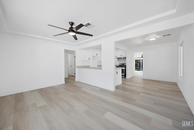 164 Rodriguez Ave, Shafter, CA 93263 - unfurnished living room with ceiling fan, light wood finished floors, and a tray ceiling