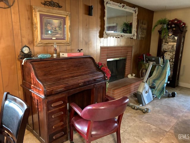 miscellaneous room with wooden walls and a fireplace