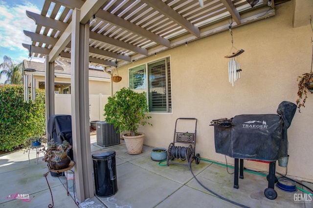 view of patio featuring central AC, a pergola, and fence