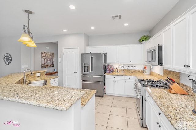 kitchen with recessed lighting, white cabinetry, high quality appliances, and a sink