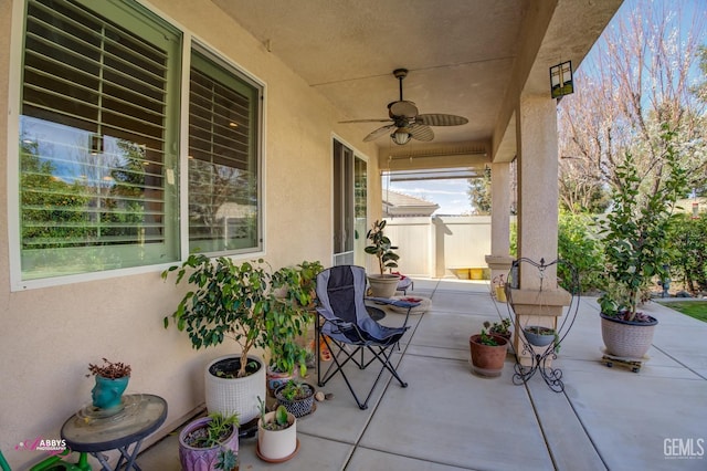 view of patio / terrace featuring ceiling fan and fence