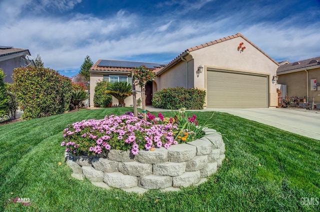 mediterranean / spanish-style home with driveway, stucco siding, a front lawn, a garage, and roof mounted solar panels