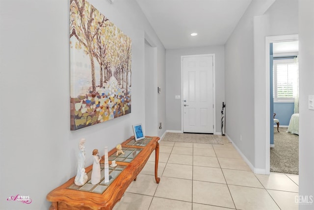 foyer with light tile patterned floors, baseboards, and recessed lighting