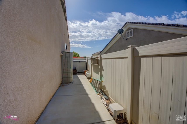 view of property exterior featuring stucco siding and fence