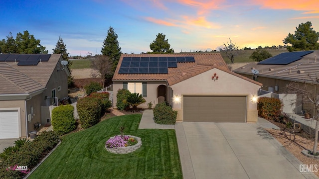 mediterranean / spanish house featuring a front lawn, a tiled roof, concrete driveway, stucco siding, and a garage