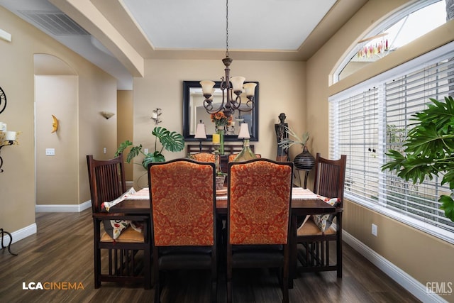 dining room with an inviting chandelier and dark hardwood / wood-style floors