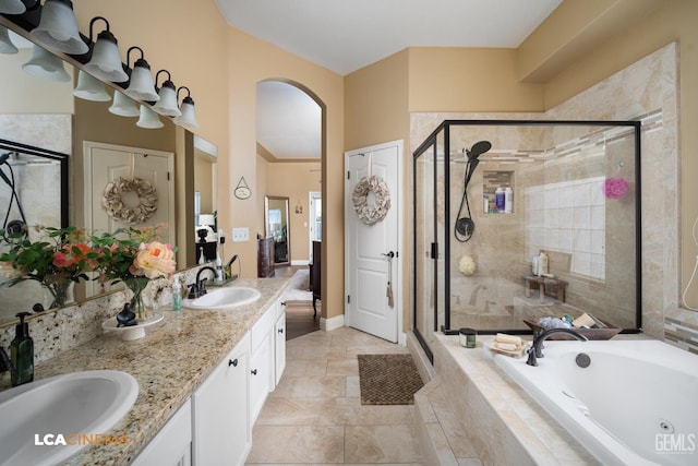 bathroom with tile patterned floors, vanity, and separate shower and tub