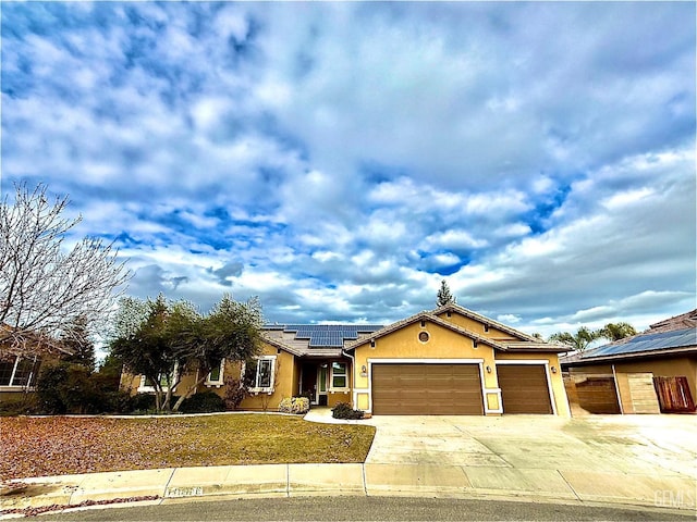 view of front of home with a garage and solar panels