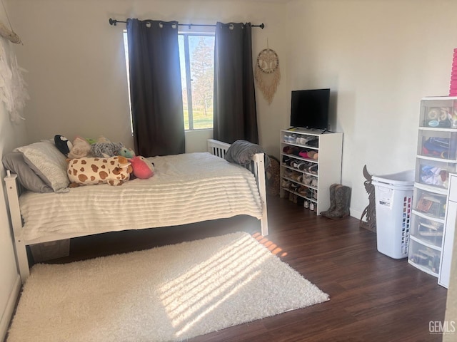 bedroom with dark wood finished floors