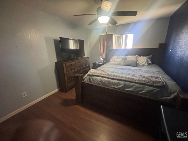 bedroom featuring dark wood-type flooring, ceiling fan, and baseboards