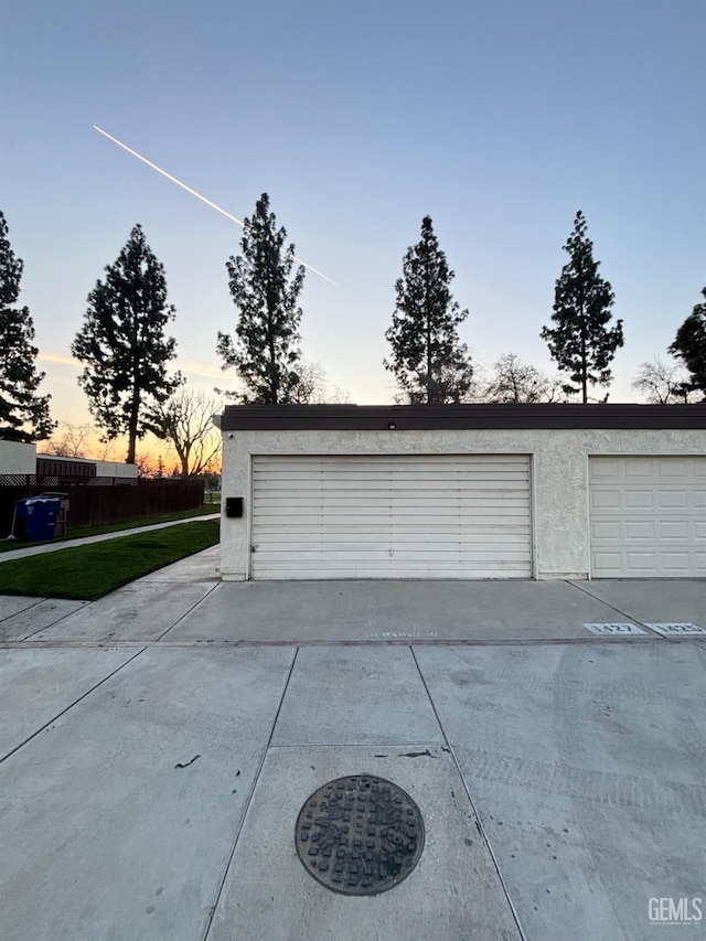 garage at dusk with driveway