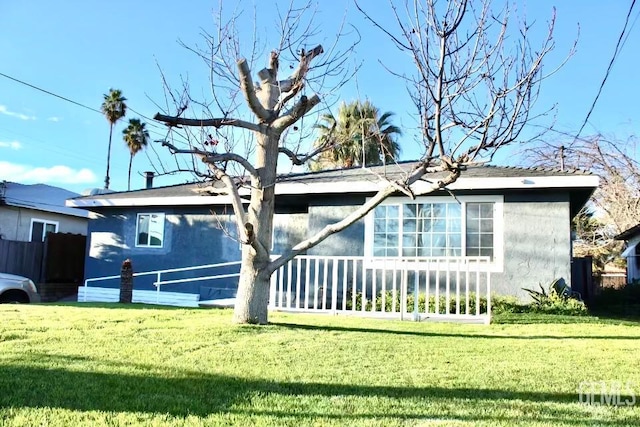 2912 Wilson Rd, Bakersfield, CA 93304 - rear view of house with a yard and stucco siding