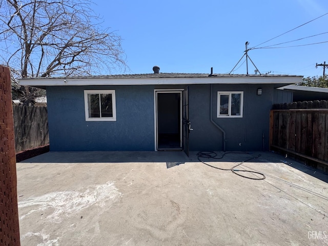 2912 Wilson Rd, Bakersfield, CA 93304 - rear view of house with stucco siding and a patio area
