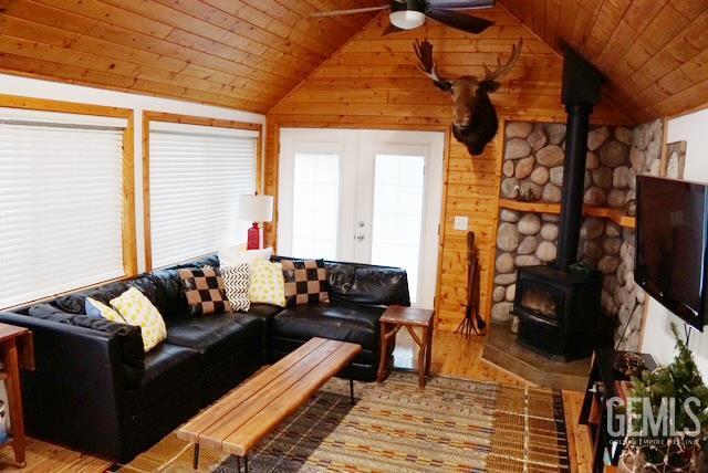 45864 Upndown Rd, Posey, CA 93260 - living room featuring a ceiling fan, lofted ceiling, wood finished floors, a wood stove, and wooden ceiling