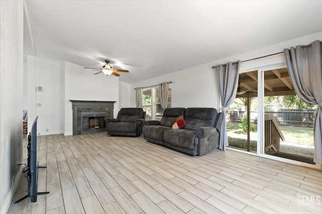 22940 Fast Ct, Bakersfield, CA 93314 - living area with ceiling fan, a glass covered fireplace, and wood finished floors