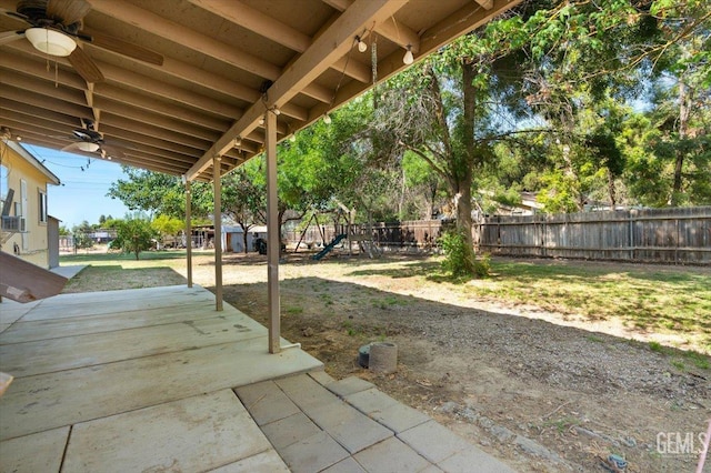 22940 Fast Ct, Bakersfield, CA 93314 - fenced backyard featuring a ceiling fan, a patio area, and a playground