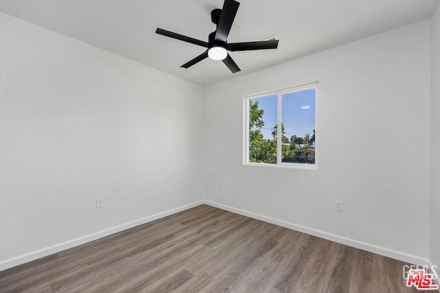 empty room featuring ceiling fan and wood-type flooring