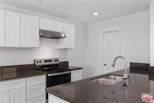 kitchen with stainless steel range with electric stovetop, sink, and white cabinets