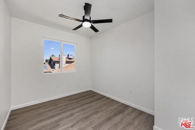 spare room featuring ceiling fan and dark hardwood / wood-style flooring