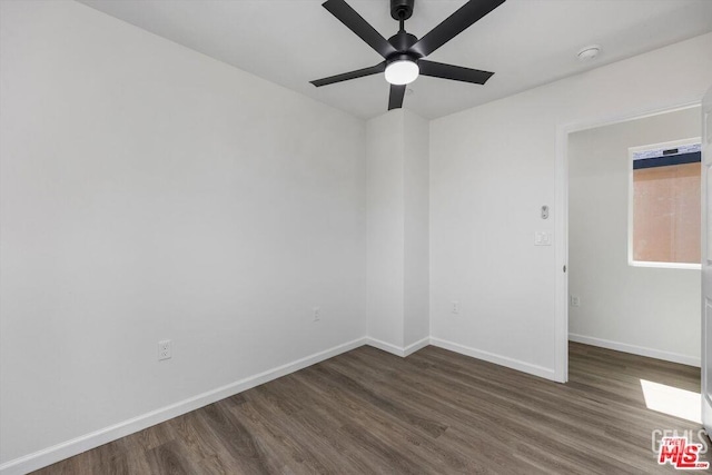 spare room featuring ceiling fan and dark hardwood / wood-style flooring