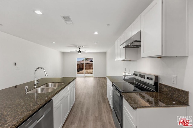 kitchen featuring dark stone countertops, sink, white cabinets, and appliances with stainless steel finishes