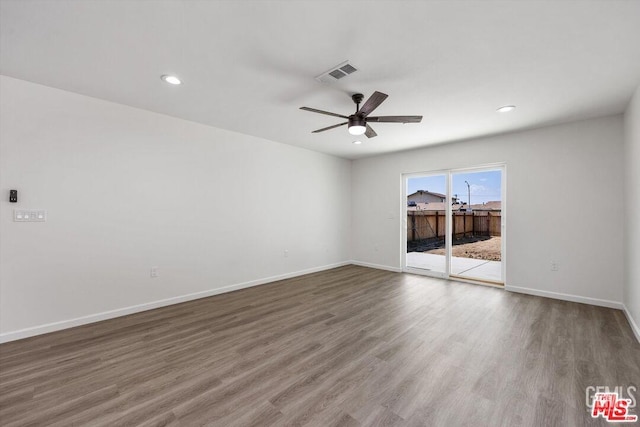 spare room with hardwood / wood-style flooring and ceiling fan