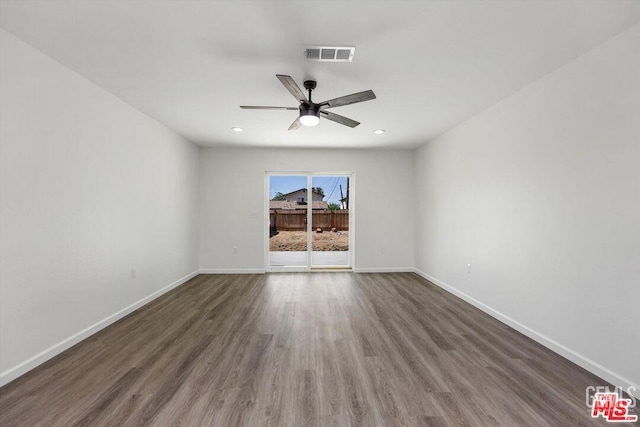 empty room with dark wood-type flooring and ceiling fan