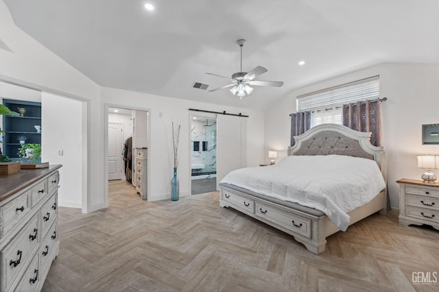 bedroom with baseboards, visible vents, vaulted ceiling, a walk in closet, and a barn door