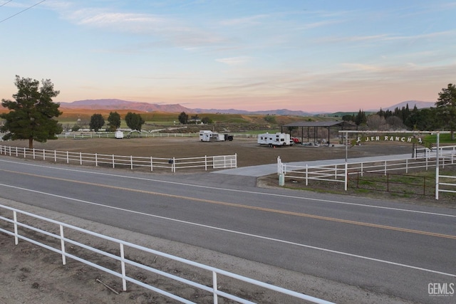 view of street with a rural view and a mountain view