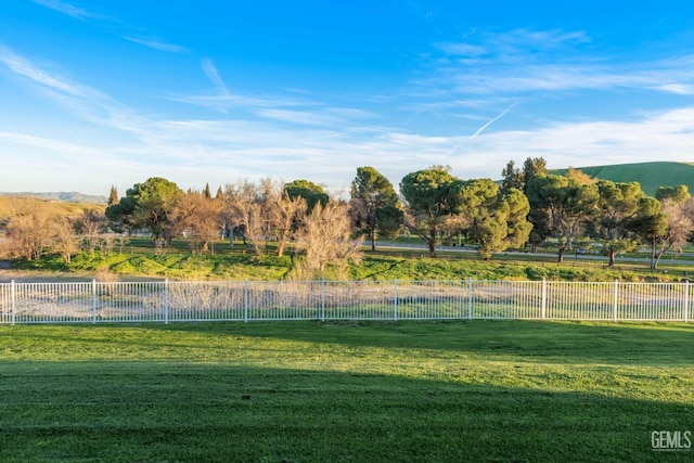 view of yard featuring a rural view and fence