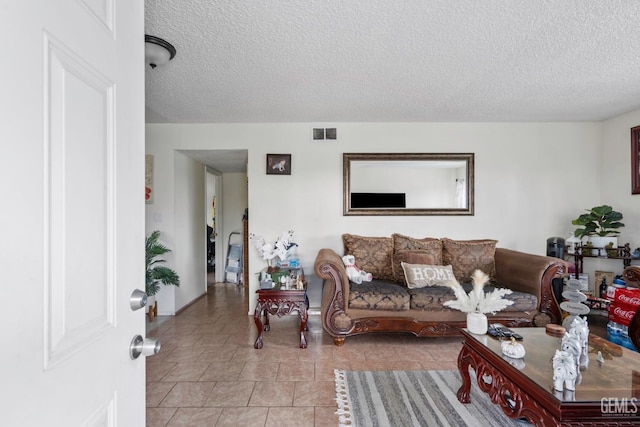 131 Eye St, Bakersfield, CA 93304 - living area with visible vents, light tile patterned flooring, and a textured ceiling