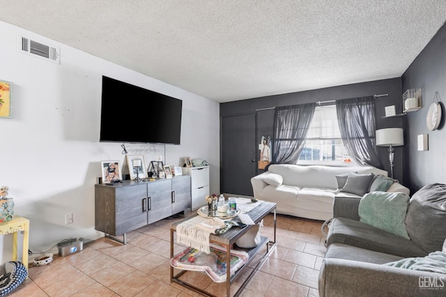 131 Eye St, Bakersfield, CA 93304 - living room with light tile patterned floors, visible vents, and a textured ceiling