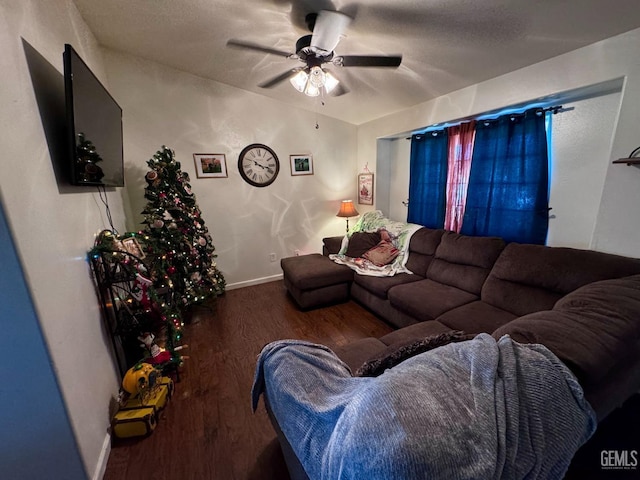 living room with ceiling fan and dark wood-type flooring