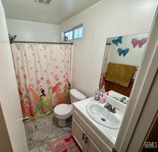 bathroom featuring vanity and toilet