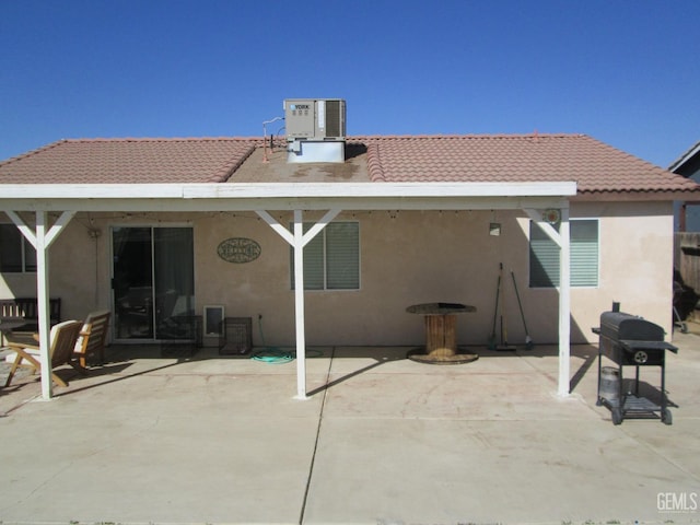 back of property featuring a patio and cooling unit