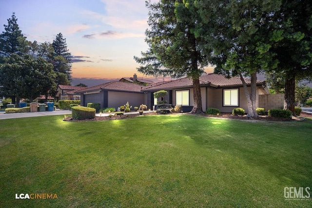 10005 Valley Forest Ct, Bakersfield, CA 93311 - ranch-style home with an attached garage, a tiled roof, a yard, and concrete driveway