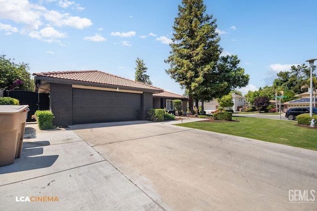 10005 Valley Forest Ct, Bakersfield, CA 93311 - ranch-style house featuring fence, an attached garage, a tile roof, concrete driveway, and a front lawn