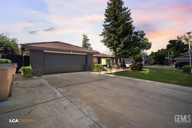 10005 Valley Forest Ct, Bakersfield, CA 93311 - view of front of house with fence, an attached garage, driveway, a tile roof, and a lawn