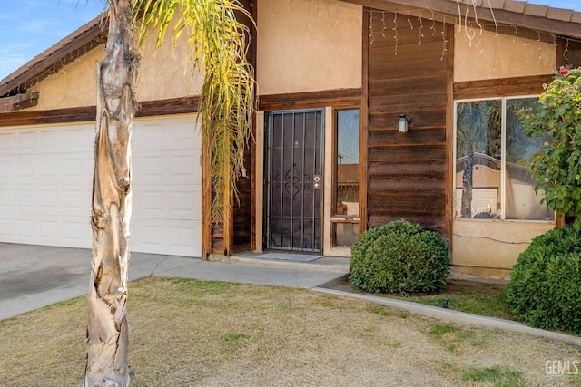 2617 Auburn Ct, Bakersfield, CA 93306 - doorway to property featuring a garage and stucco siding