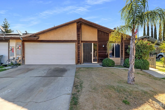 2617 Auburn Ct, Bakersfield, CA 93306 - view of front of home featuring an attached garage, driveway, and stucco siding