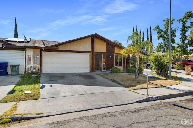 2617 Auburn Ct, Bakersfield, CA 93306 - view of front of house with a garage, concrete driveway, and solar panels