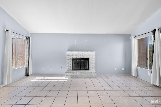 2617 Auburn Ct, Bakersfield, CA 93306 - unfurnished living room featuring vaulted ceiling, a fireplace, and light tile patterned floors