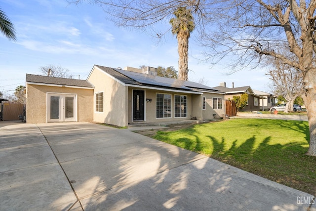 exterior space with a front yard and solar panels